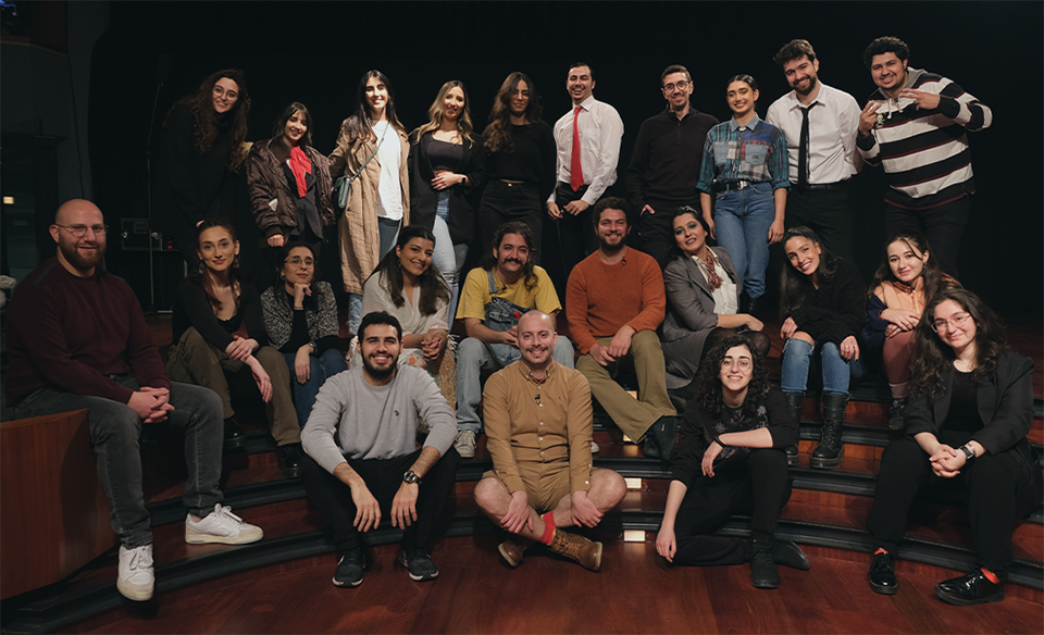 A group of people posing at various angles in a movie theatre.