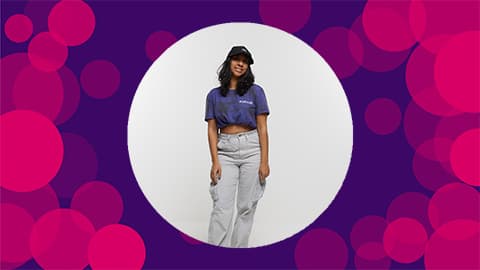 A purple background with pink circles on with an image of Uma wearing a printed shirt with the Askari logo on it in the middle of the canvas. 