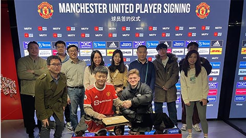 Group of Alumni at Manchester United museum in Beijing smiling