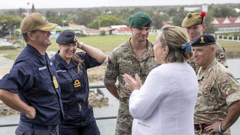 UK Minister for the Indo-Pacific Anne-Marie Trevelyan meets British participants of Pacific Partnership 2023. There are six people in the image, five of whom are wearing military uniforms.