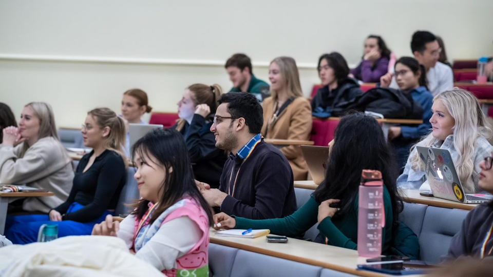 People sat in seats in a lecture theatre