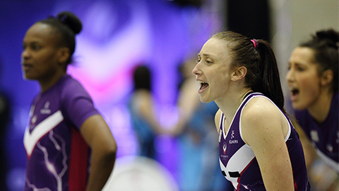 A side profile image of Jade Clarke wearing Loughborough Lightning kit. Two other netballers are in the background of the image. Image courtesy of Still Sport Photography.