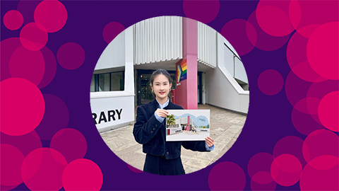 A purple background with pink circles on with Abby holding an illustration of Pilkington Library in front of Pilkington Library.
