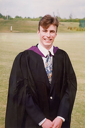 Chris Martin wearing a graduation gown