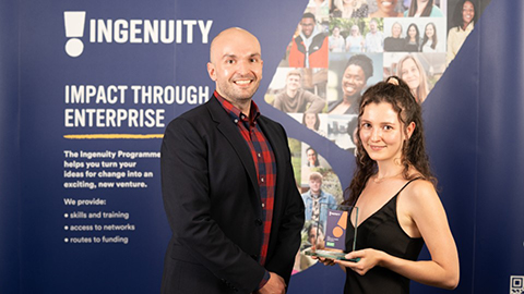 Katie Michaels holding her Ingenuity health champion award