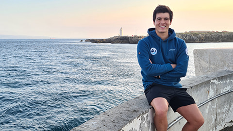 Andy Donaldson sat on a wall by the ocean