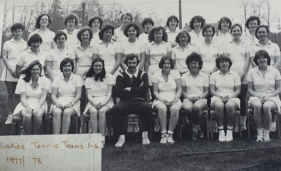 A black and white image of the first ladies tennis team. 27 seven women posing in three different rows in tennis kit with Rod Thorpe sitting in the middle of the front row. In the bottom left corner it reads ' Ladies Tennis Teams 1-4 1977/'78.