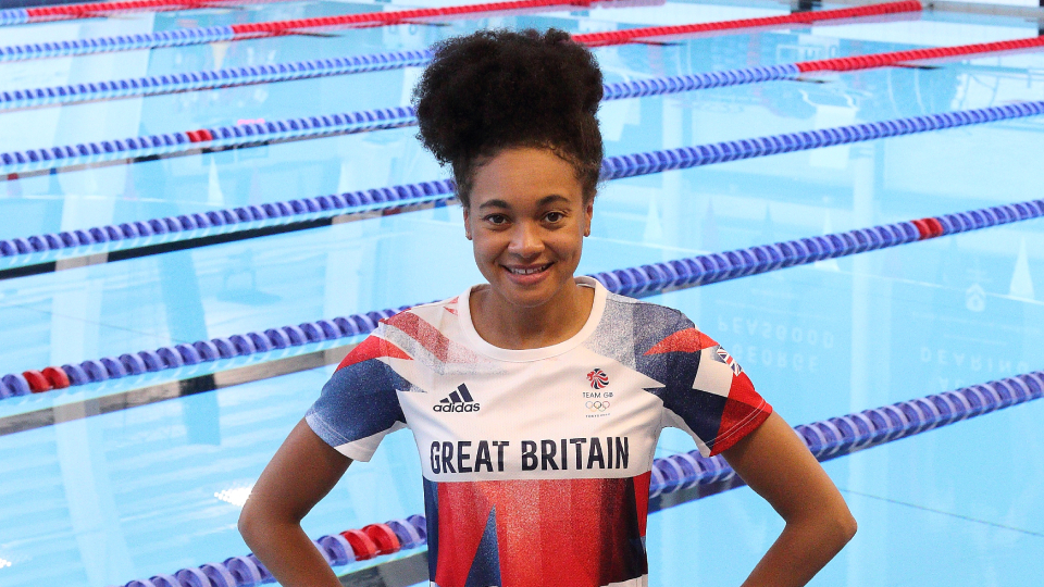 Alice Dearing in a Team GB top standing at a pool