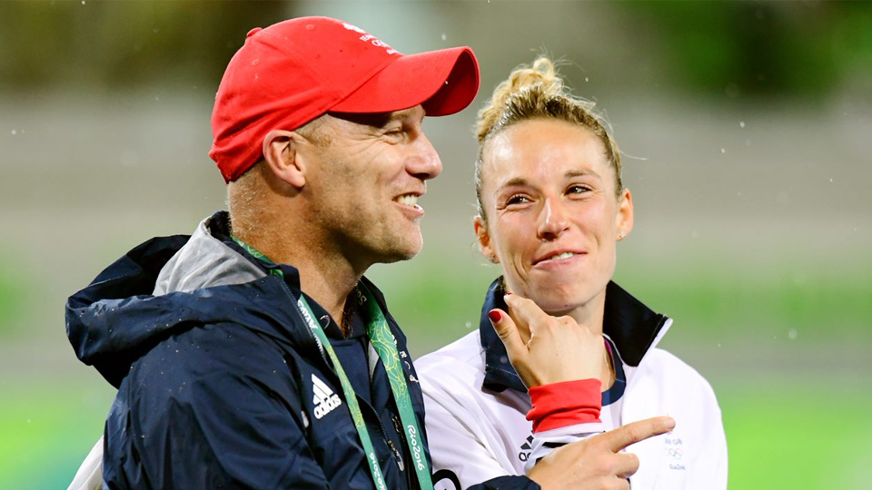 Danny Kerry is pictured outside wearing a cap as he stands talking to a hockey player