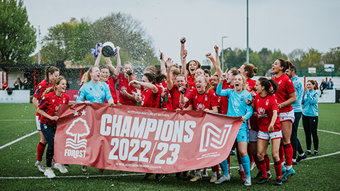 Nottingham Forest Women holding a banner celebrating becoming League champions. Image: Ami Ford