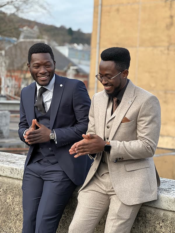 The two Kabarter co-founders smiling in suits.