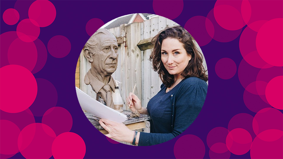 An image of Keziah smiling towards the camera. She is holding paper and a sculpting tool. To the left of the image is the bust of King Charles III in progress. She stands in front of a garden fence. The image is featured in the centre of a purple background with pink spots around the sides.