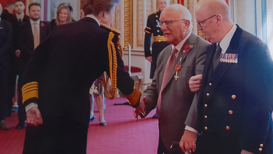 Peter Liddle shaking hands with Princess Anne as he receives his award