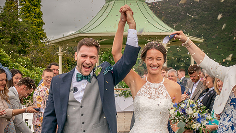 Ryan and Rosie holding hands at their wedding