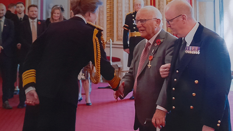 Peter Liddle shaking hands with Princess Anne as he receives award