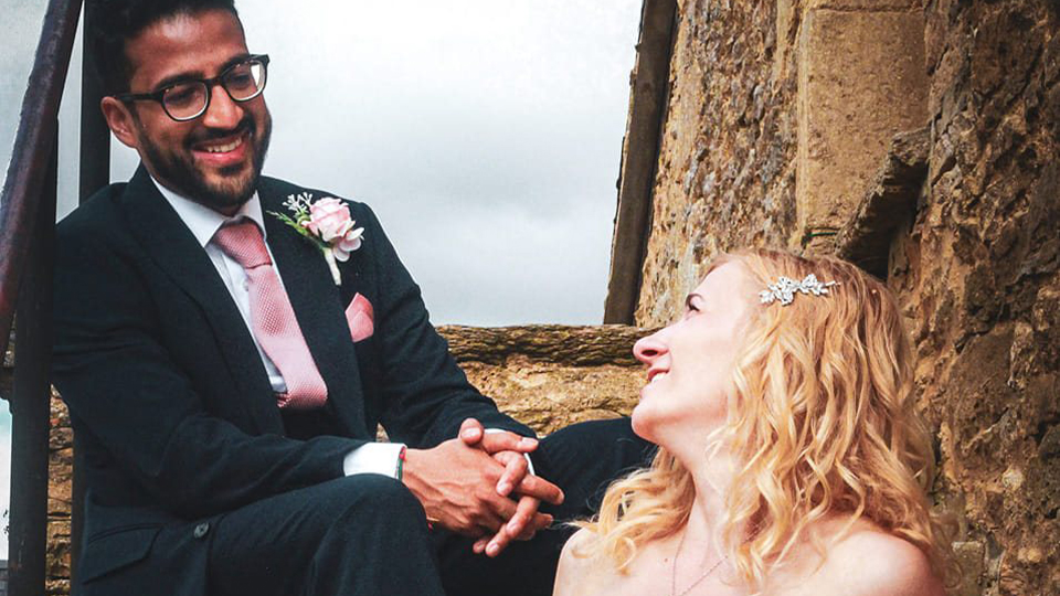 Chloe and husband smiling at each other on wedding day