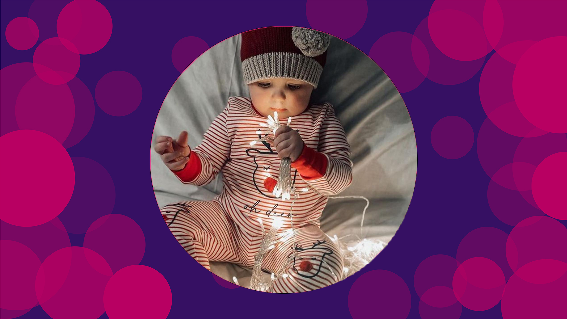 A purple background with pink circles with an image of a baby wearing charlotte wills designs and holding fairy lights