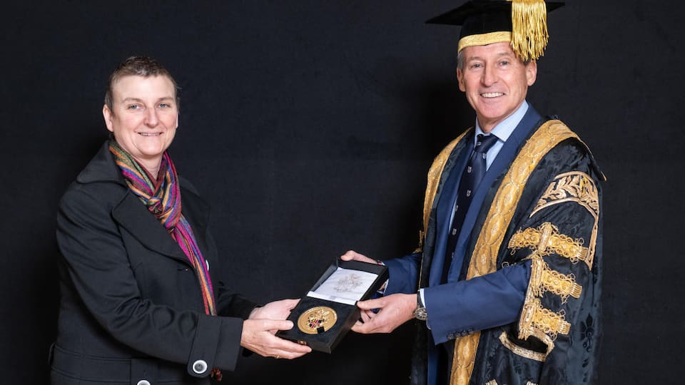 Kaz Setchell receiving her University Medal from Lord Coe.