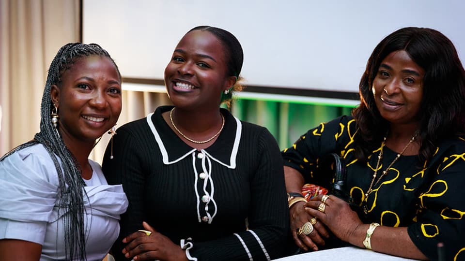 Three people smiling