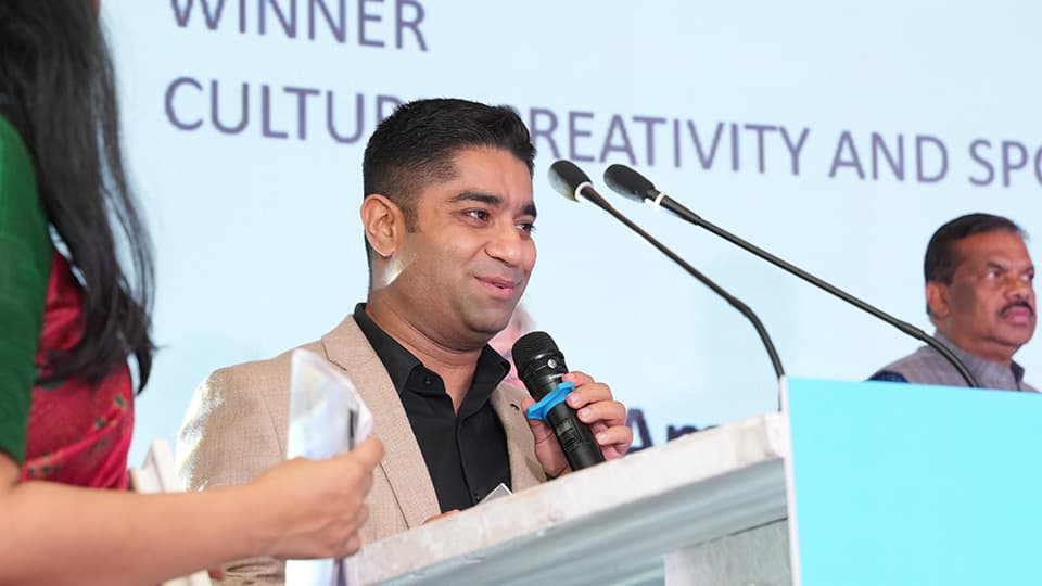 Aman Dhall holding a microphone