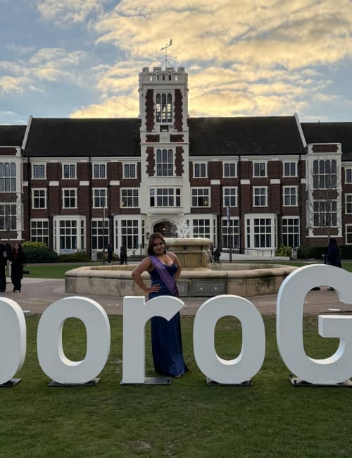 Ash outside the Hazlerigg Building on campus at graduation