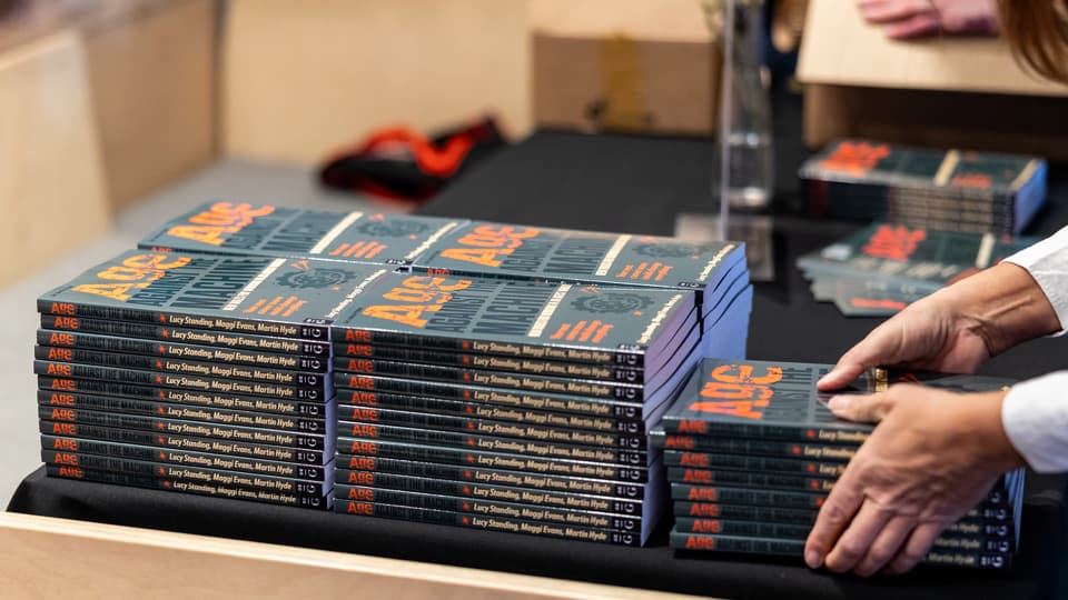 Piles of books on a table.