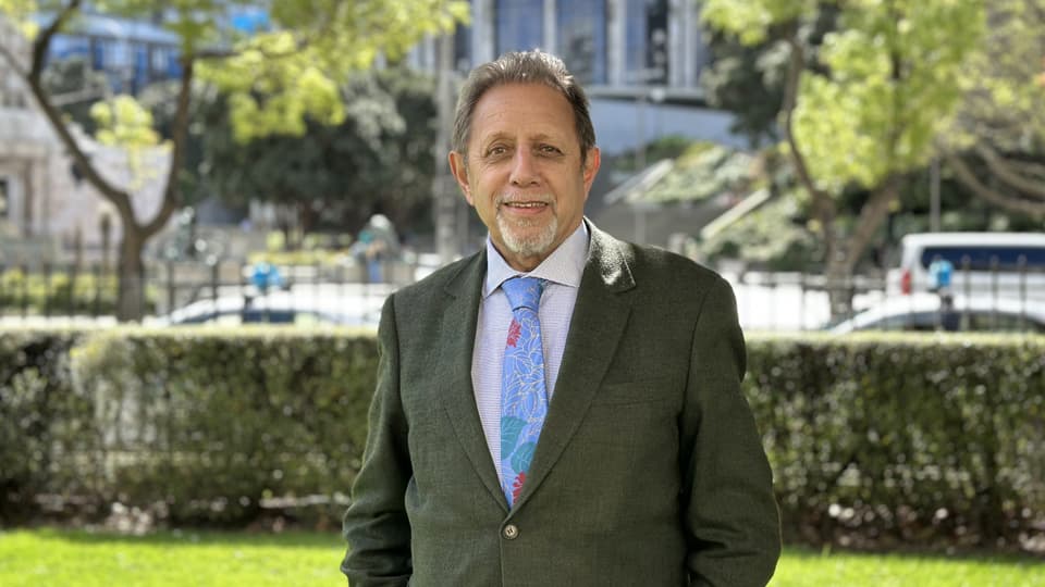 Hugh Lawrence standing outside, wearing a suit