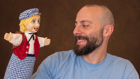 Gaby Milky looking at a puppet