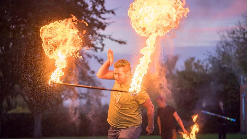 a person with flaming torches