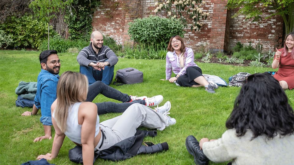 a group of students sitting on the grass