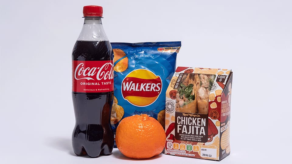 Food Items - crisps, fruit, wrap and a bottled drink