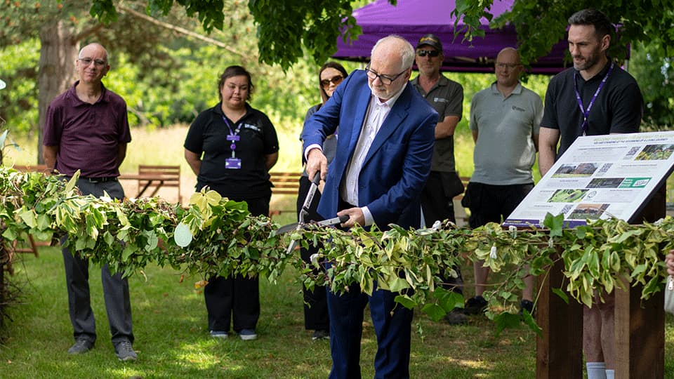 Vice-chancellor, Nick Jennings, cuts nature ribbon with staff standing behind