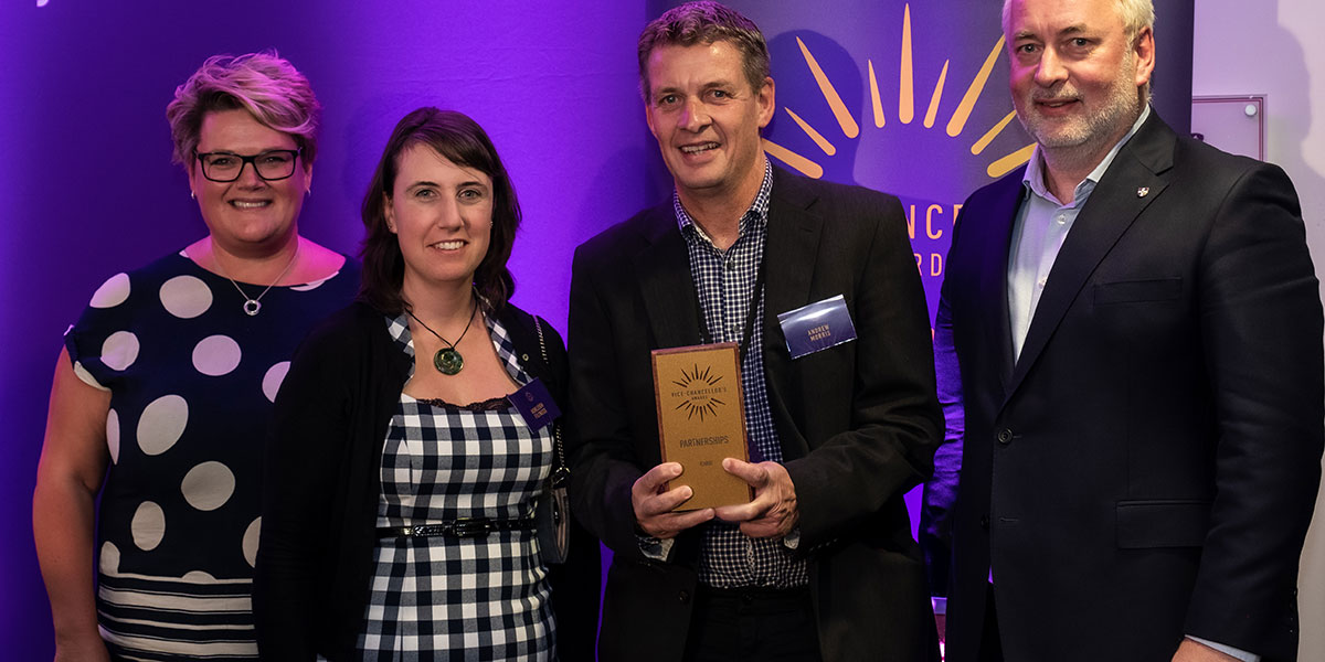 Two members of the ICAROS team receiving their award from Alex Owen, Chief Financial Officer and Professor Nick Jennings, Vice-Chancellor