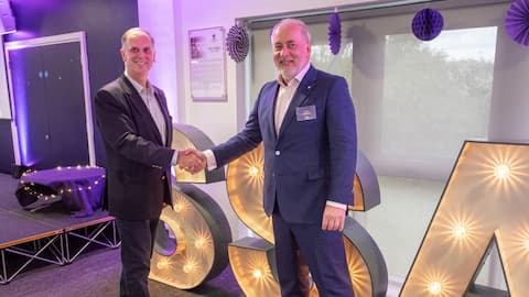 Chris Gill shaking hands with Professor Nick Jennings