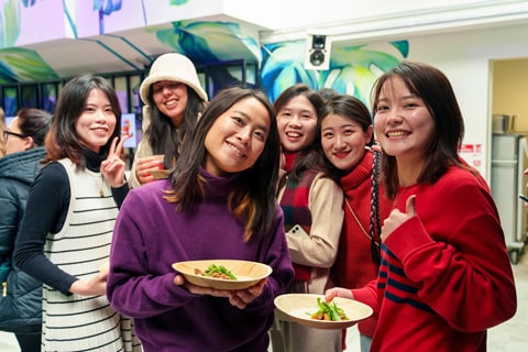 People smiling and eating food