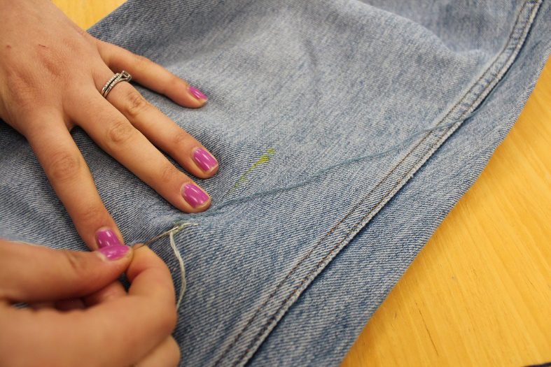 Student sewing fabric