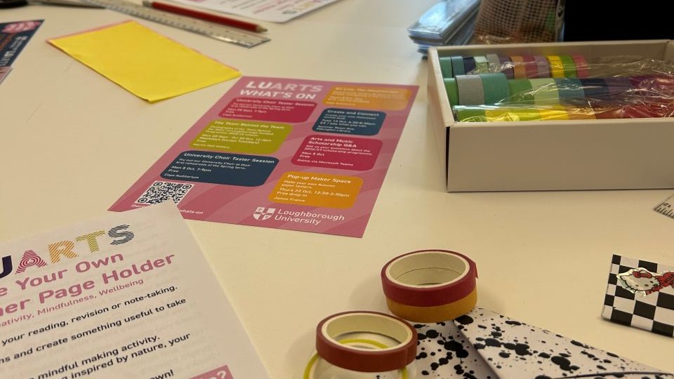 Craft session set up on tables with printed handouts, washi tape, paper, pens and so on