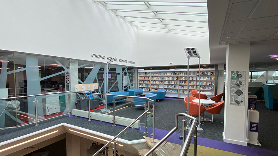Blue and orange chairs in a grey library space