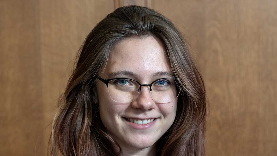 Young white female in her early twenties with long brown hair and glasses
