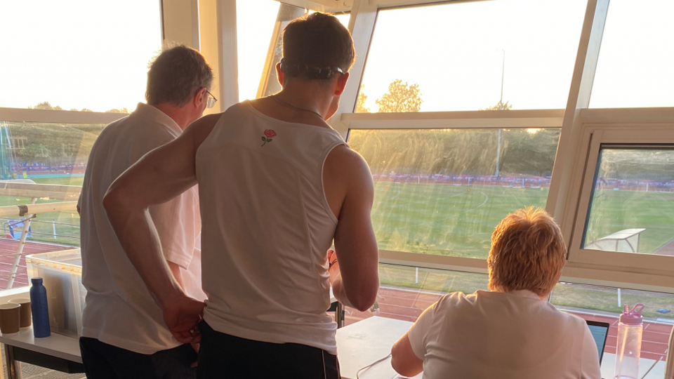 Coaches looking out from the Powerbase balcony