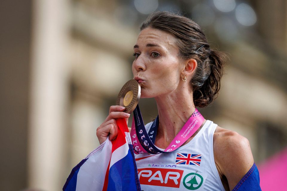 Doctoral Researcher Abbie Donnelly kisses the bronze medal she won in the marathon at the 2026 European Athletics Championships