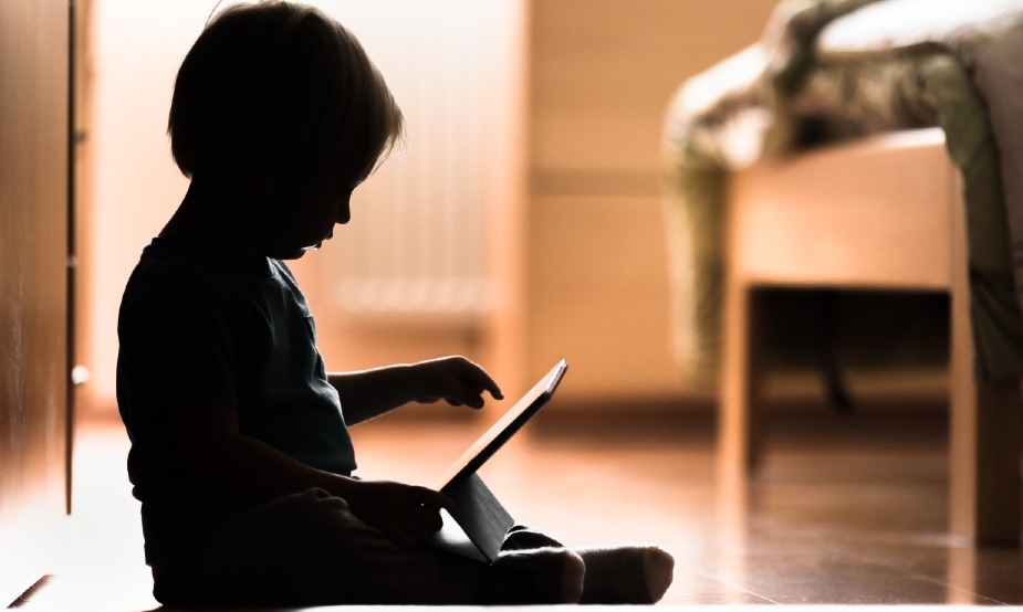 A baby sat with a tablet