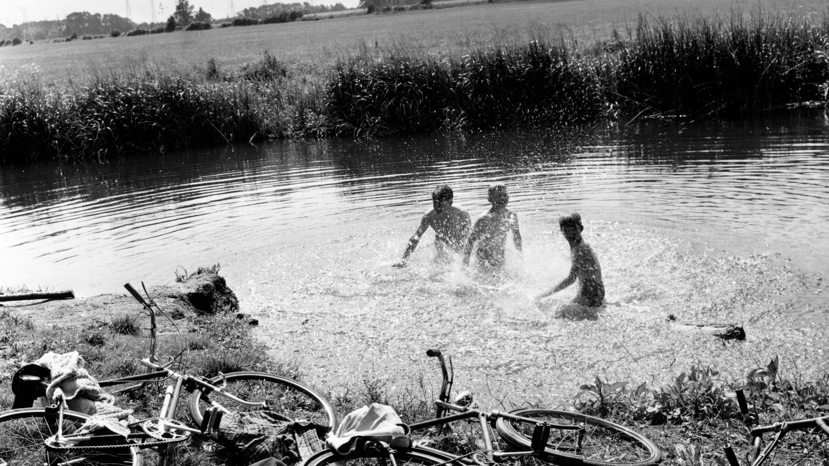 children cooling off in water during heatwave