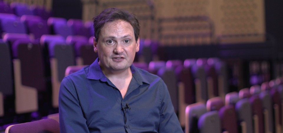 Prof Marcus Collins of Loughborough University sitting in an empty theatre