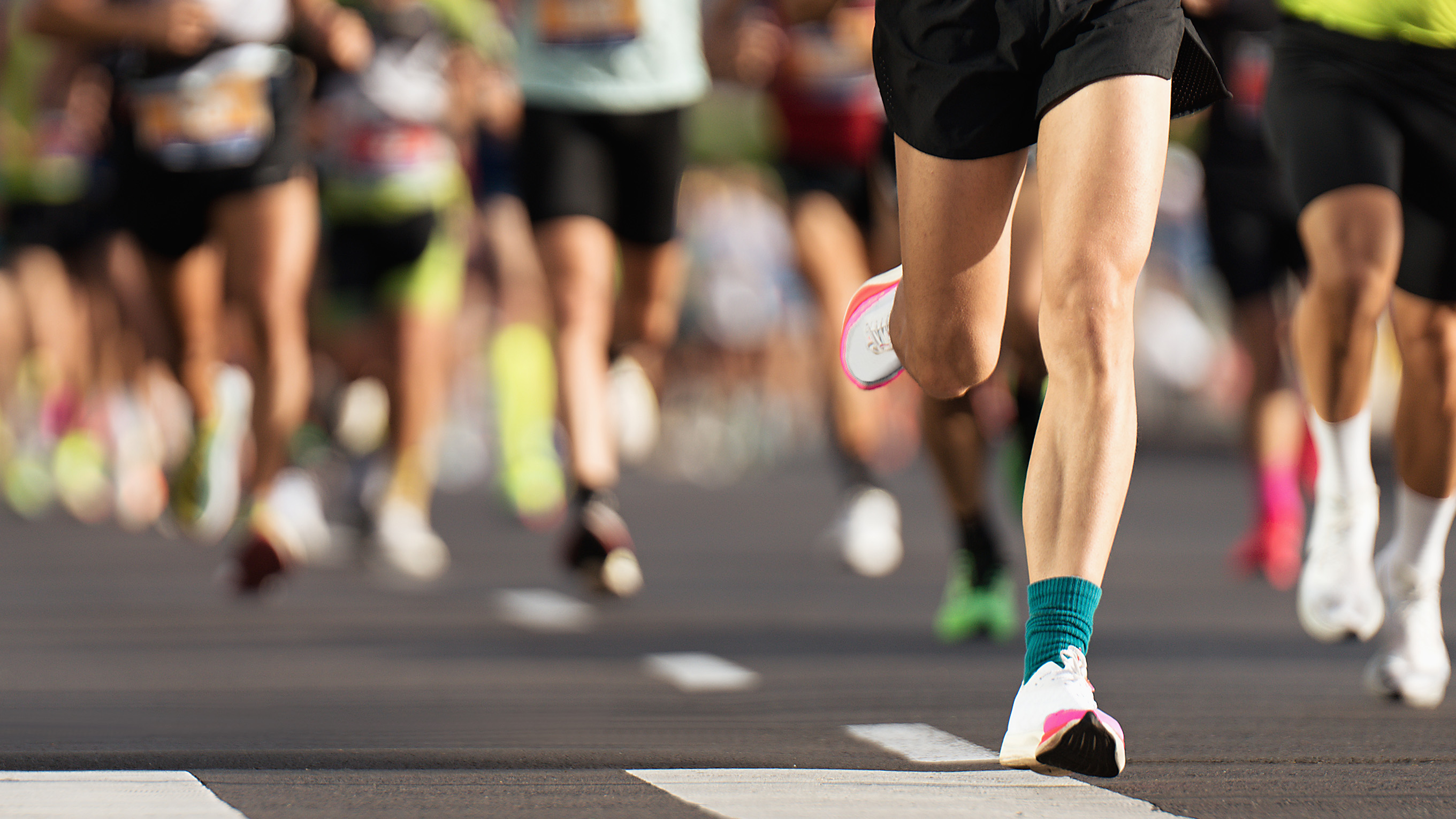 group of runners running along road