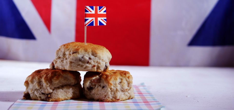 a plate of scones with a union jack flag poking out
