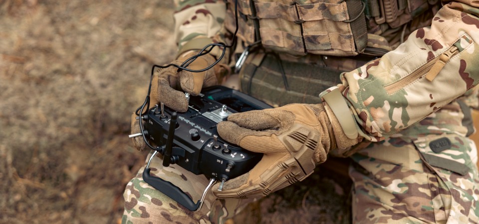 A soldier operates a drone with a controller