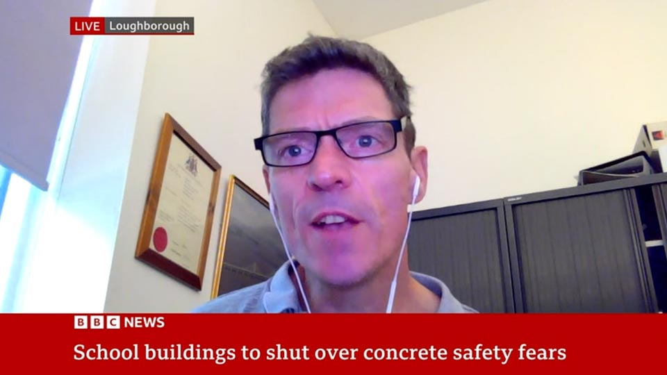A screenshot of Chris Goodier on a video call being interviewed by BBC News. A caption reads: School buildings to shut over concrete safety fears