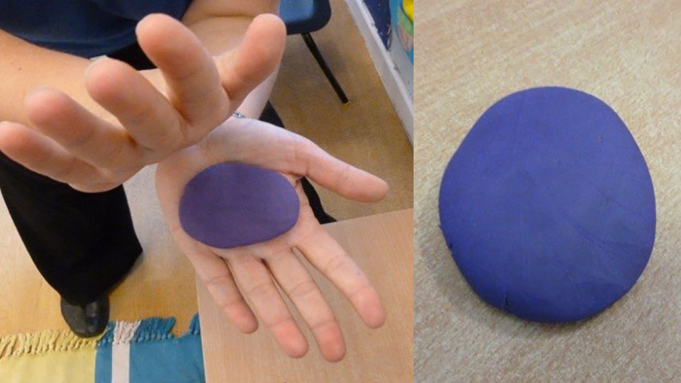 Hands squashing a ball of dough into a pancake shape