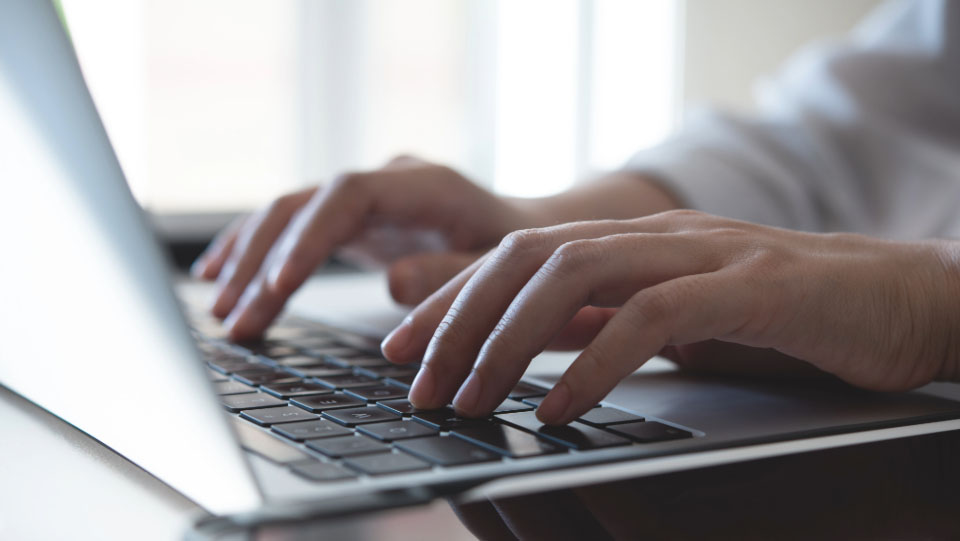 Hands using a laptop